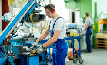 35663926 - worker in protective clothing in factory using machine